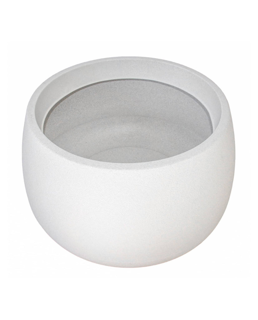 Angled view of the low rise round, off white, plant pot. Ultra modern architectural design